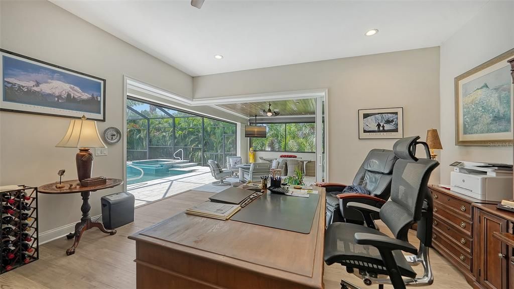 Office on the main floor  overlooking the covered lanai and pool.