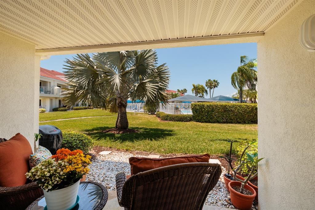 YOUR COVERED OUTDOOR PATIO JUST STEPS FROM THE POOL! ALSO VIEW FROM LIVING ROOM.