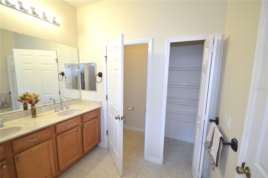 Duel sinks, private water closet and linen closet in the primary bathroom.