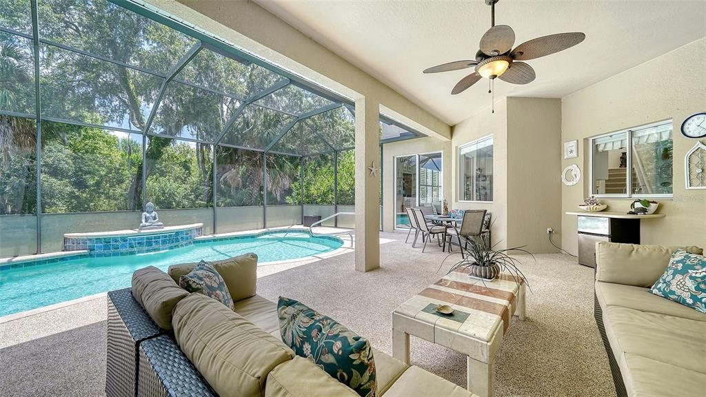 Favorite part of the home! Outdoor under roof space capturing Florida indoor/ outdoor living!