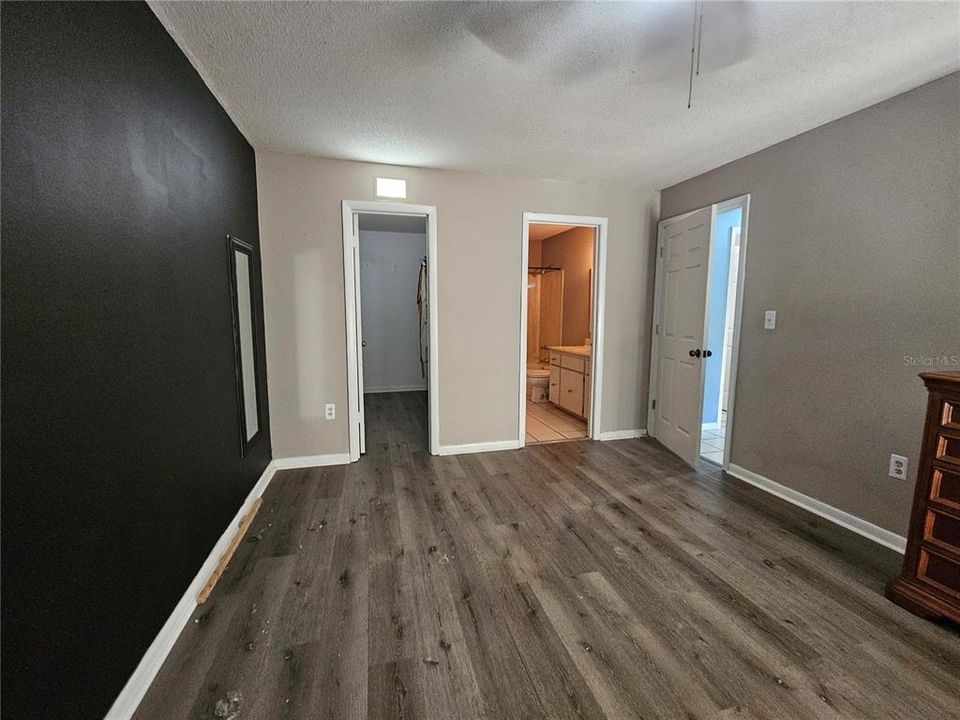 Primary Bedroom looking towards the large walk-in closet and Primary Bathroom entrance.