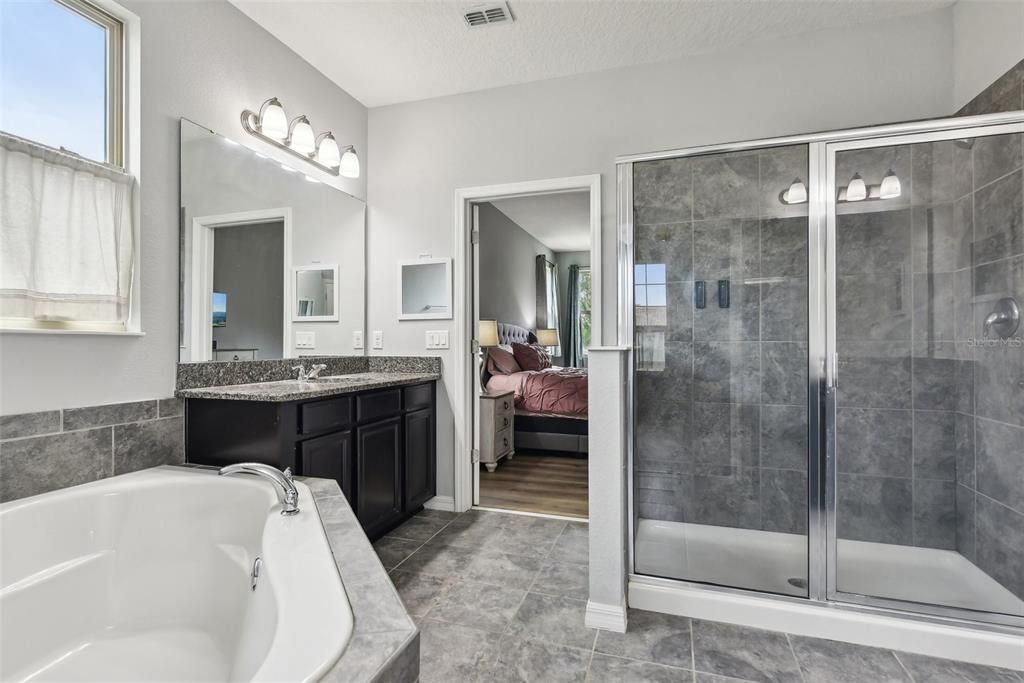 The PRIMARY SUITE is a LARGE and SPACIOUS PRIMARY SUITE with very ELEGANT BATHROOM FEATURES such as a GARDEN TUB, SPLIT DOUBLE VANITIES, a SEPARATE OVERSIZED STAND UP SHOWER and a PRIMARY CLOSET the SIZE OF A ROOM!