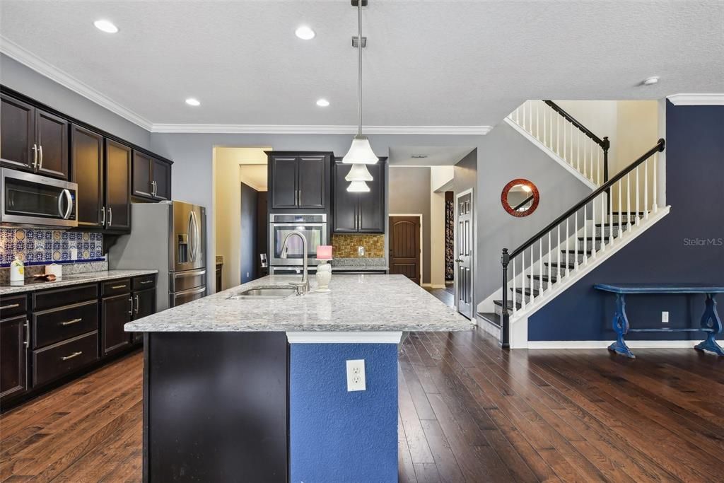 OVERSIZED CHEF’S KITCHEN with LOTS OF COUNTER AND CABINET SPACE, a WALK IN PANTRY and an OVERSIZED ISLAND overlooking the LARGE FAMILY ROOM. BEAUTIFULLY MAINTAINED WOOD FLOORS cover the majority of the DOWNSTAIRS LIVING SPACE.