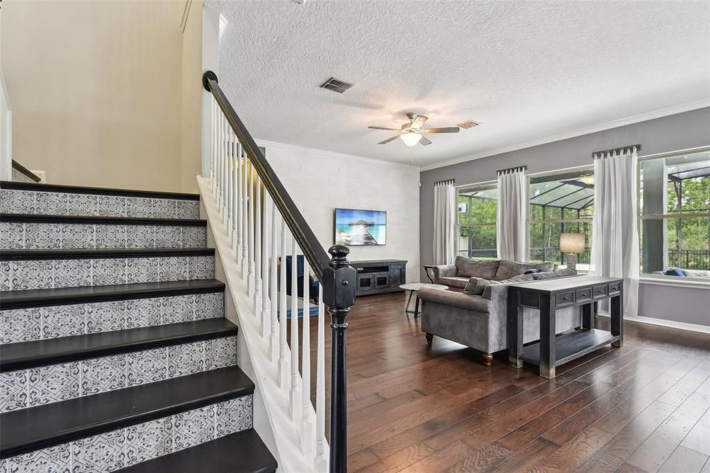 WOOD STAIRS with CUSTOM TILE WORK, then you are IMMEDIATELY GREETED with an OVERSIZED LOFT that measures over 450 sqft! The LOFT is PERFECT for a GAME ROOM, MOVIE ROOM, BILLIARDS ROOM, a COMBINATION of those things or just a RELAXING SPOT to hangout and recharge!