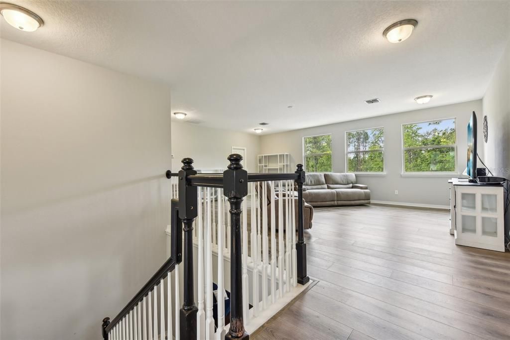 WOOD STAIRS with CUSTOM TILE WORK, then you are IMMEDIATELY GREETED with an OVERSIZED LOFT that measures over 450 sqft! The LOFT is PERFECT for a GAME ROOM, MOVIE ROOM, BILLIARDS ROOM, a COMBINATION of those things or just a RELAXING SPOT to hangout and recharge!