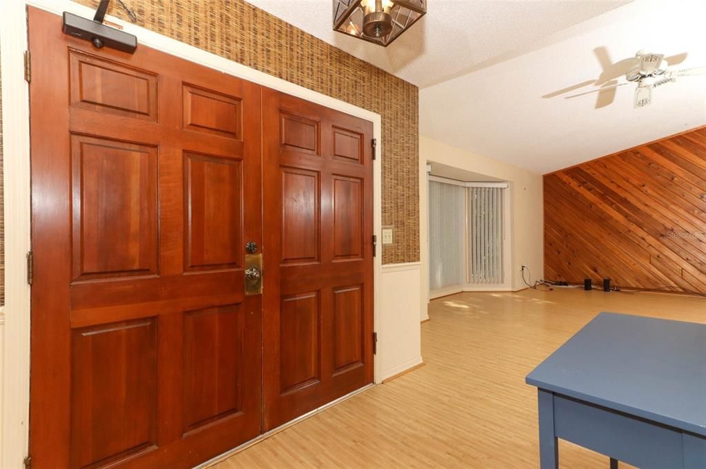 Double solid wood doors with large foyer.