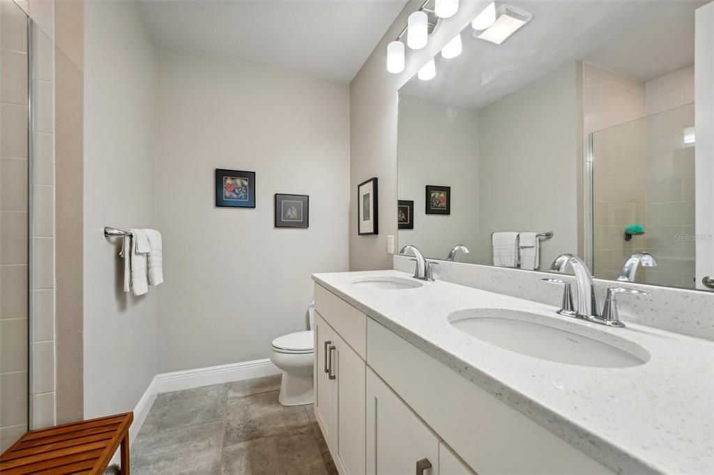 Large shower with tile to the 10' ceiling