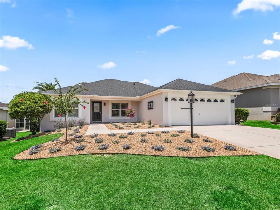 ENHANCED LANDSCAPING, NEW EXTERIOR PAINT AND A NEW ROOF