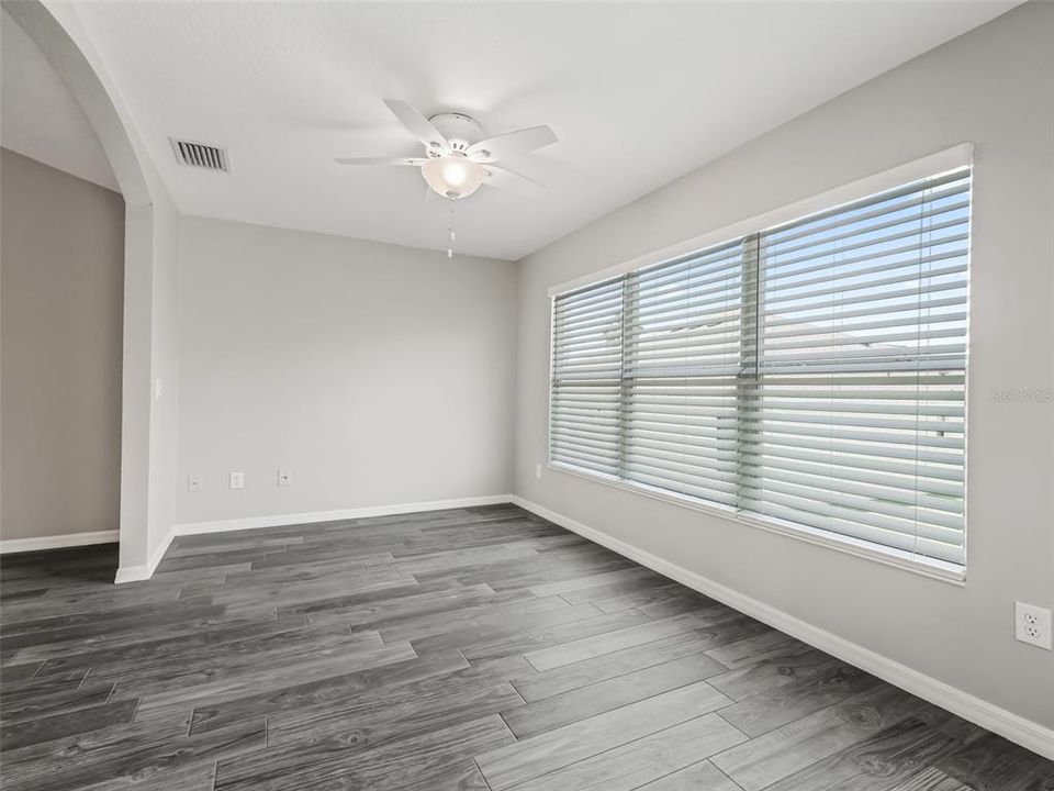 FLORIDA ROOM WITH WINDOWS LOOKING OUT TO THE REAR YARD