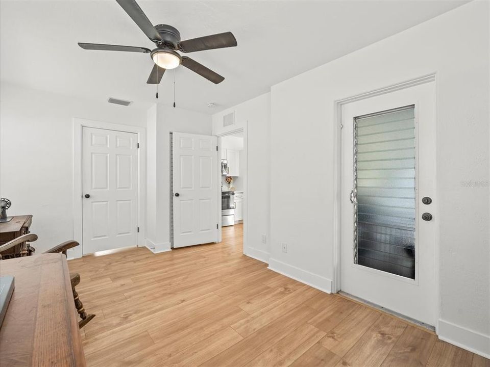 The door on the left is where the washer and dryer would go and the water heater is there. The door on the right goes out to the backyard and as you can see, the open door flows to the kitchen