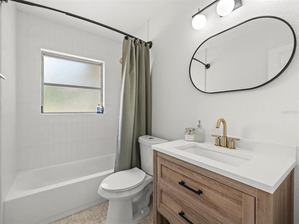 This bathroom has the most lux finishes.... gold accents and don't forget to check out the floor. Mirror included.