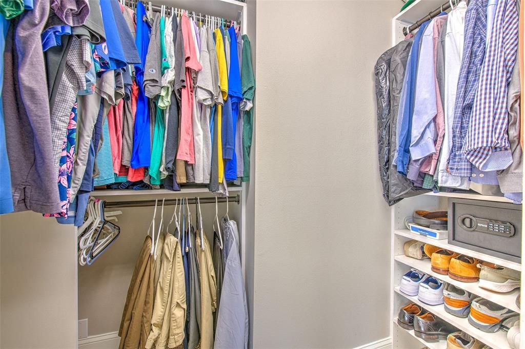 Primary walk in closet with custom built ins