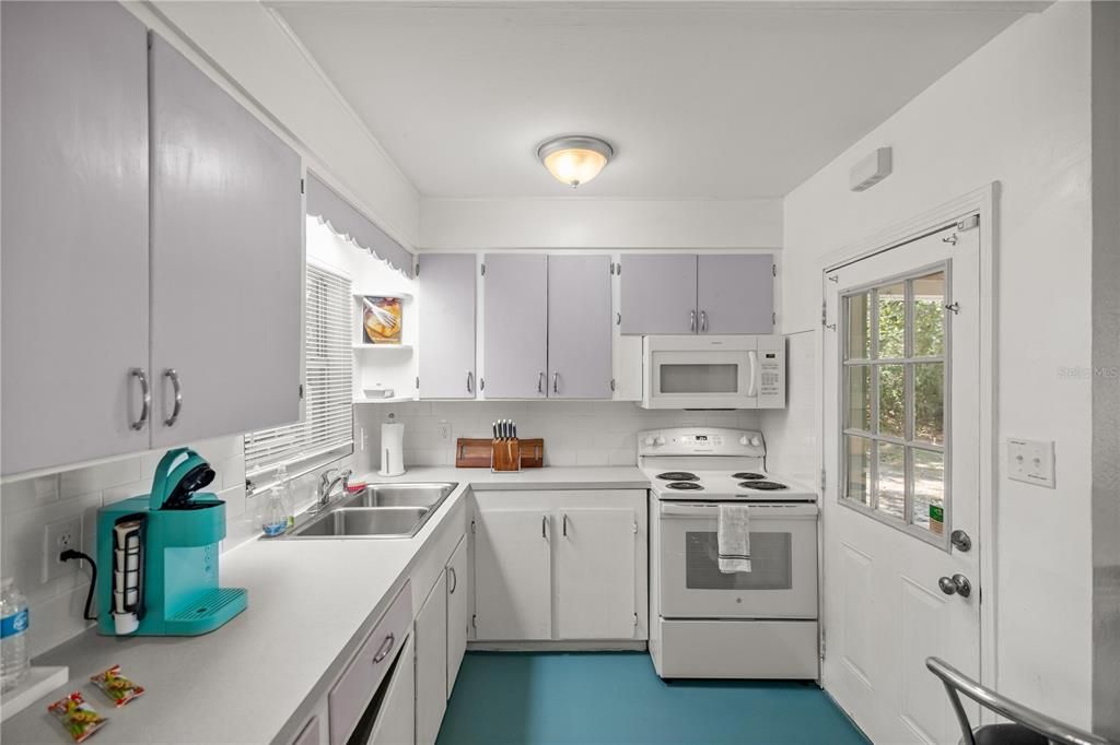 brand new lower kitchen cabinets with fresh paint on the upper cabinets.