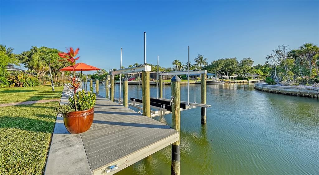 Private boat dock offering a composite deck, electric & water, kayak rack and boat lift up to 10,000 lbs. Can accommodate up to 45' motorboat.