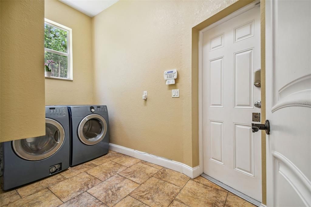 Laundry room with LARGE pantry, laundry chute & door leading to your paved paradise