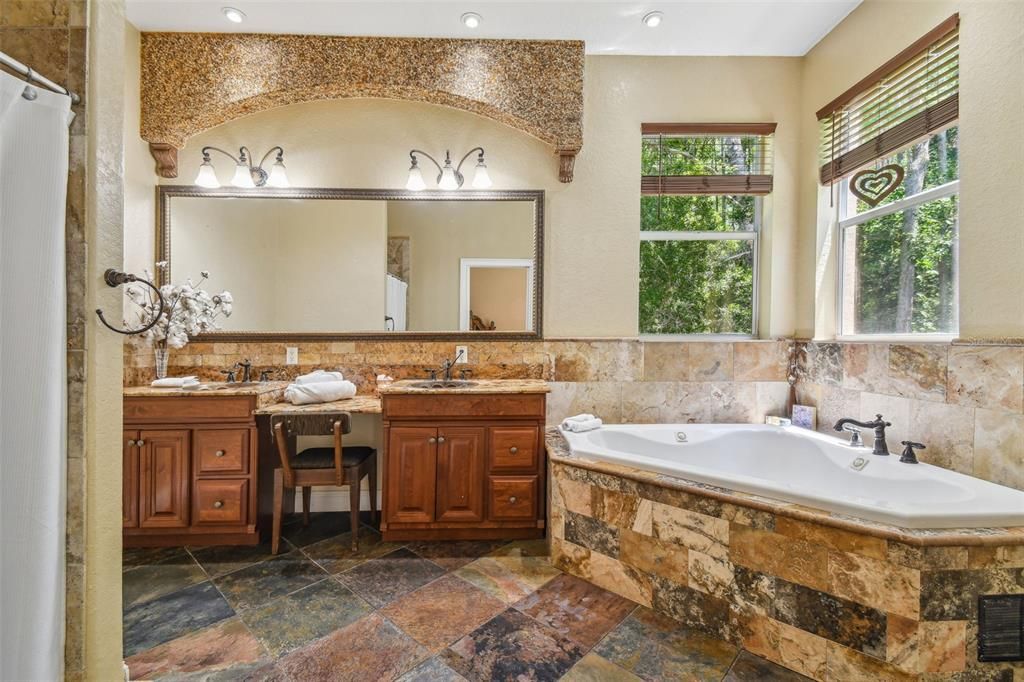 Primary bathroom with a jacuzzi garden tub and separate shower