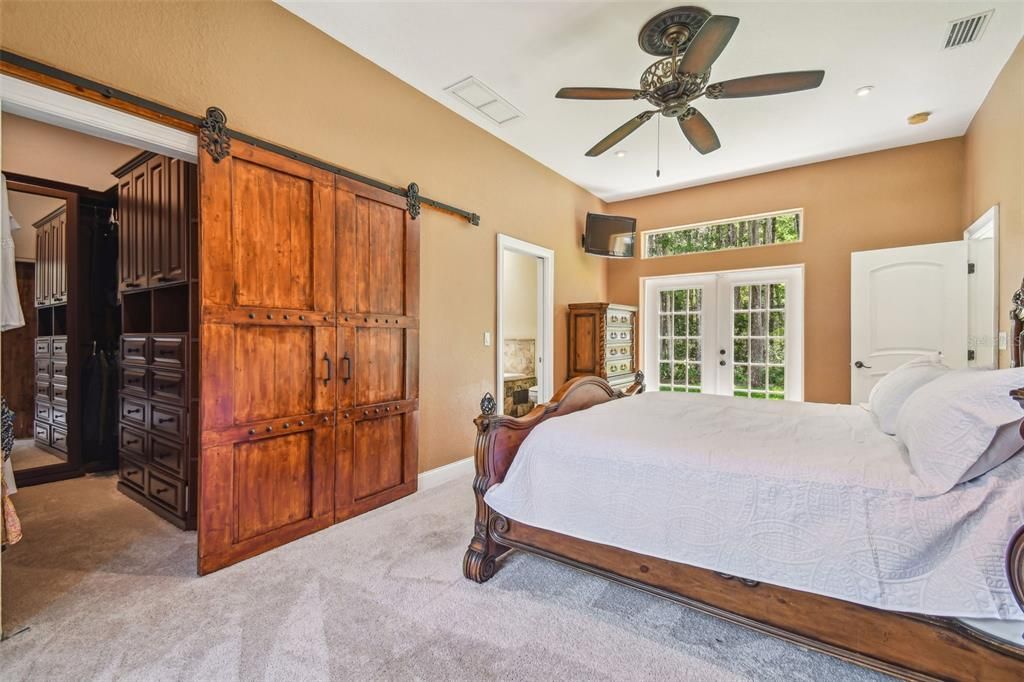 HUGE walk in California Closet with custom sliding barn door.