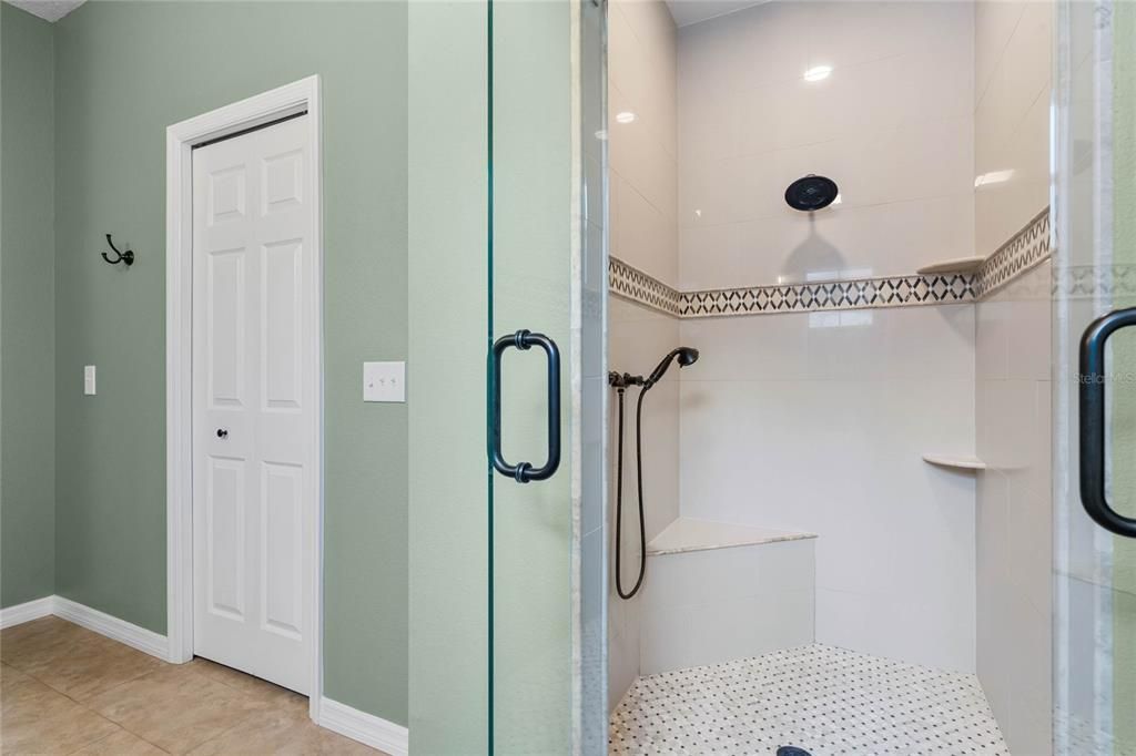 Seated Shower with Decorative Listello Tile and Double Glass Doors