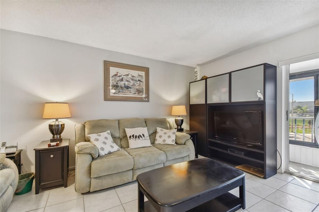 Living Room with sliding glass doors to enclosed L shaped porch