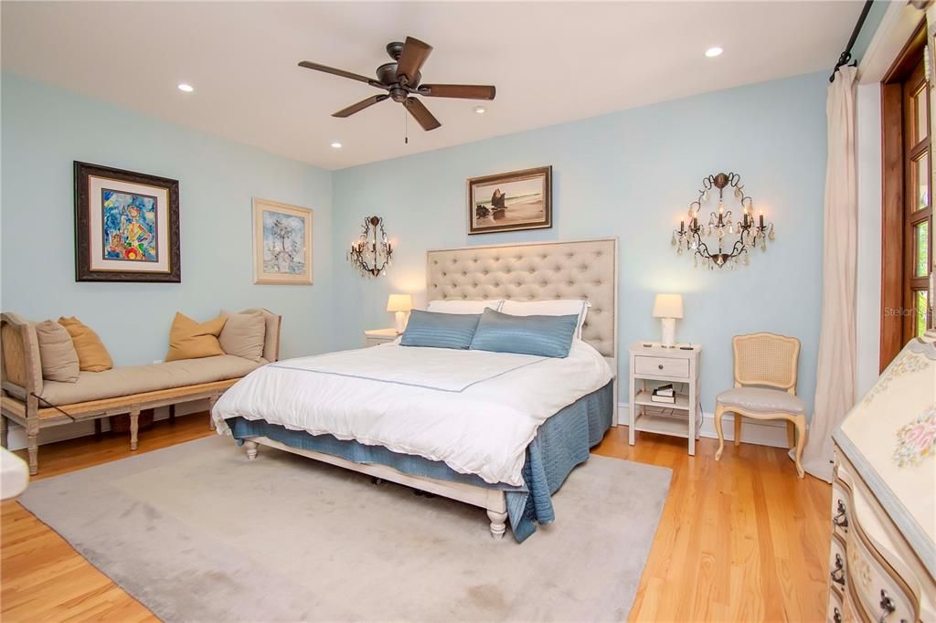 Hallway with desk area leads to primary bedroom