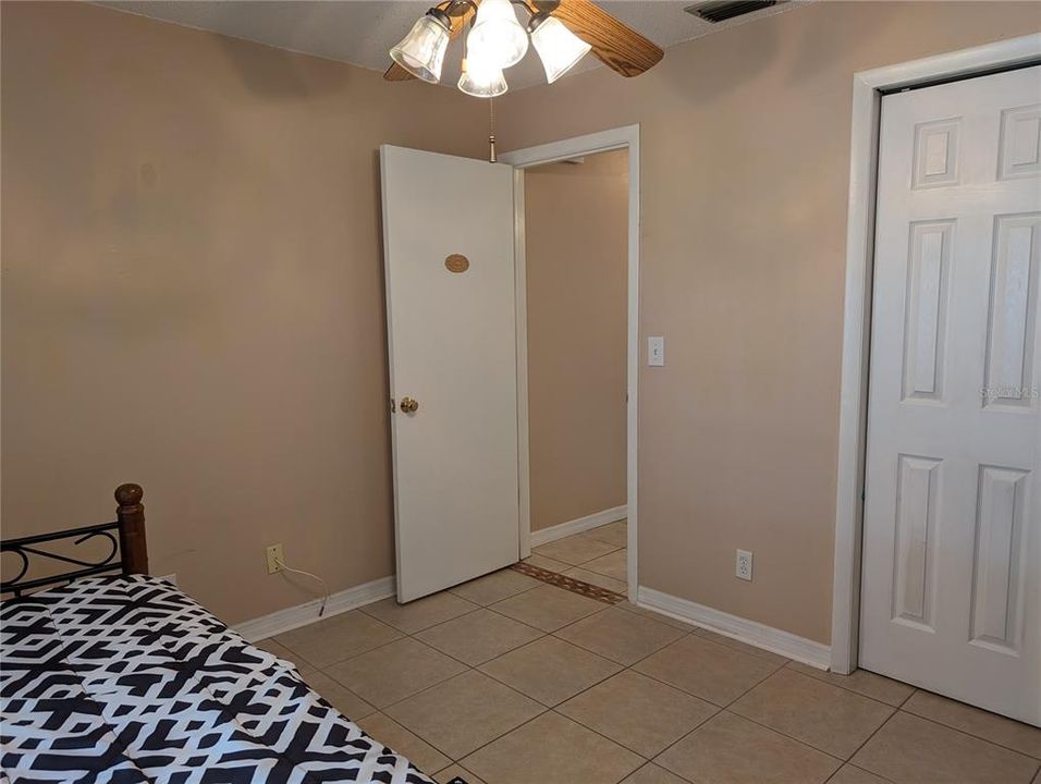 Guest bedroom is located at opposite end of the hallway from primary bedroom.