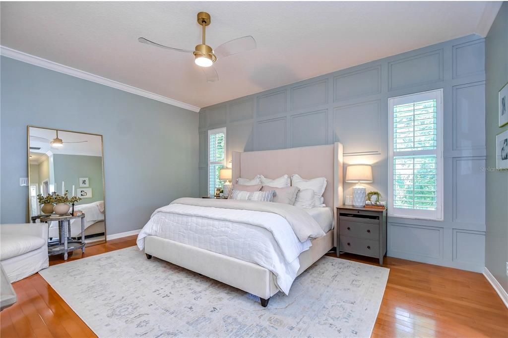 Primary suite is a true retreat with beautiful hardwood floors, an accent wall and his and her closets!