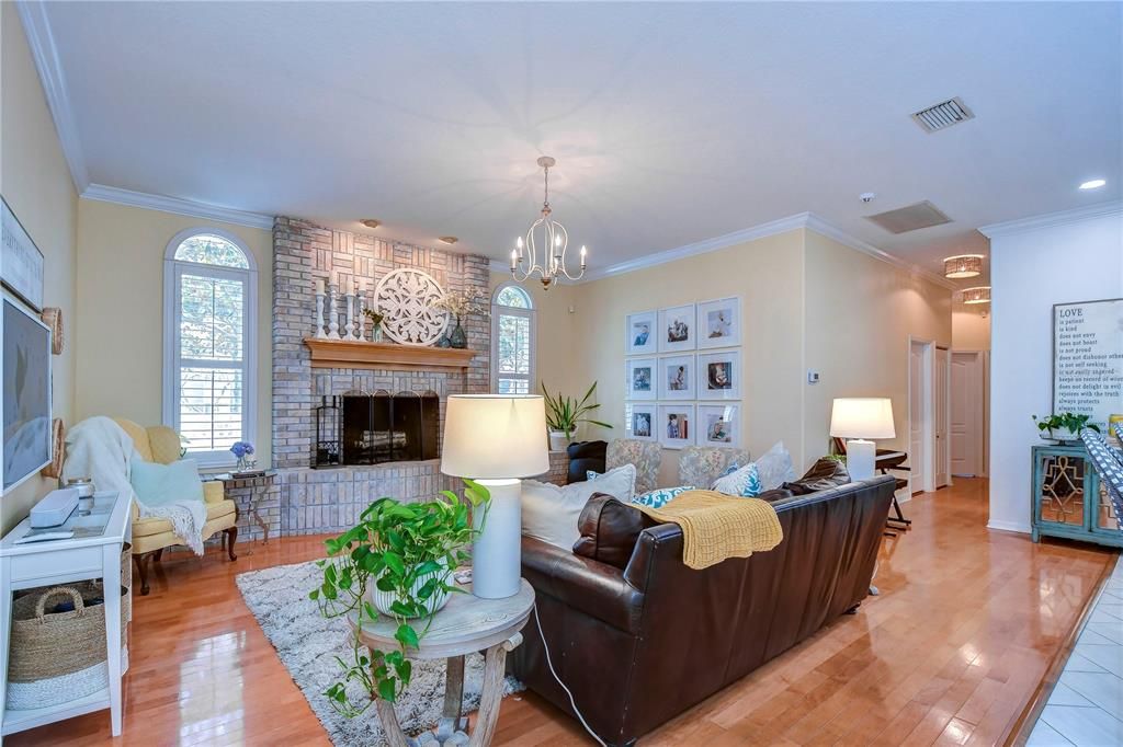 Spacious family room features beautiful hardwood floors and a stunning wood-burning fireplace!