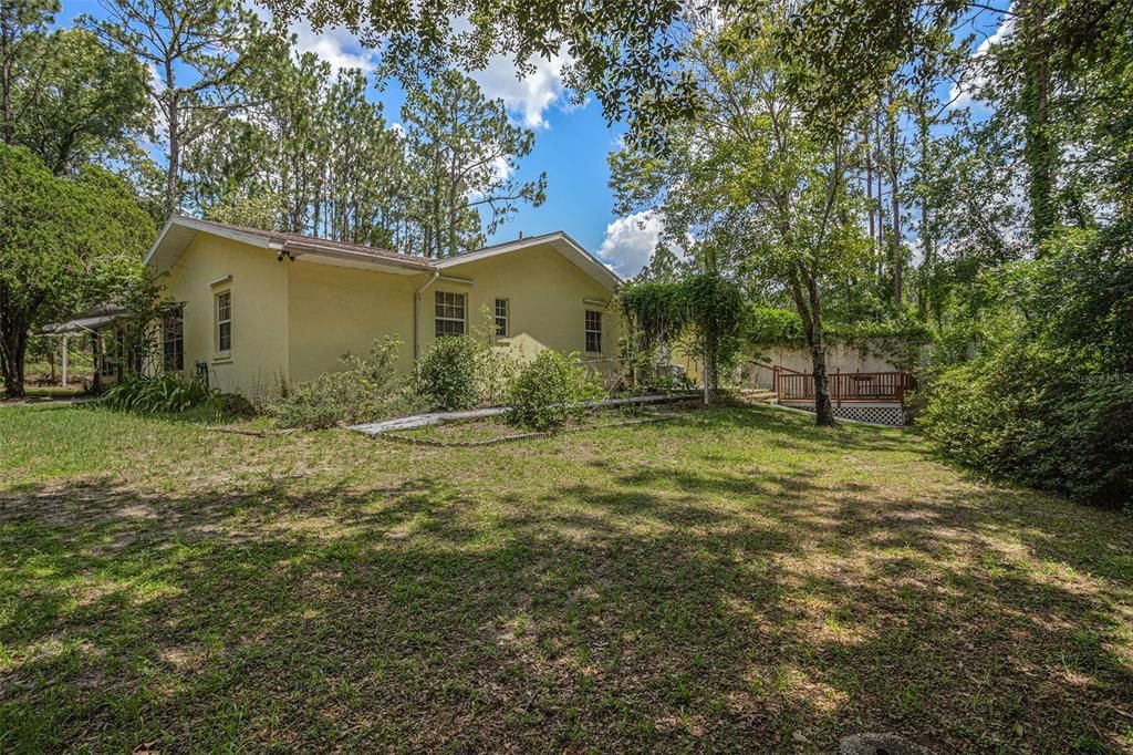 0.40 acres _ Expansive property overflowing with mature trees and vibrant azaleas.