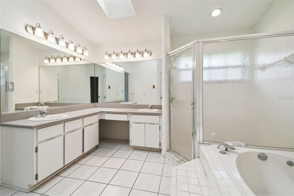 Primary bathroom with dual sinks, walk-in shower and garden tub.