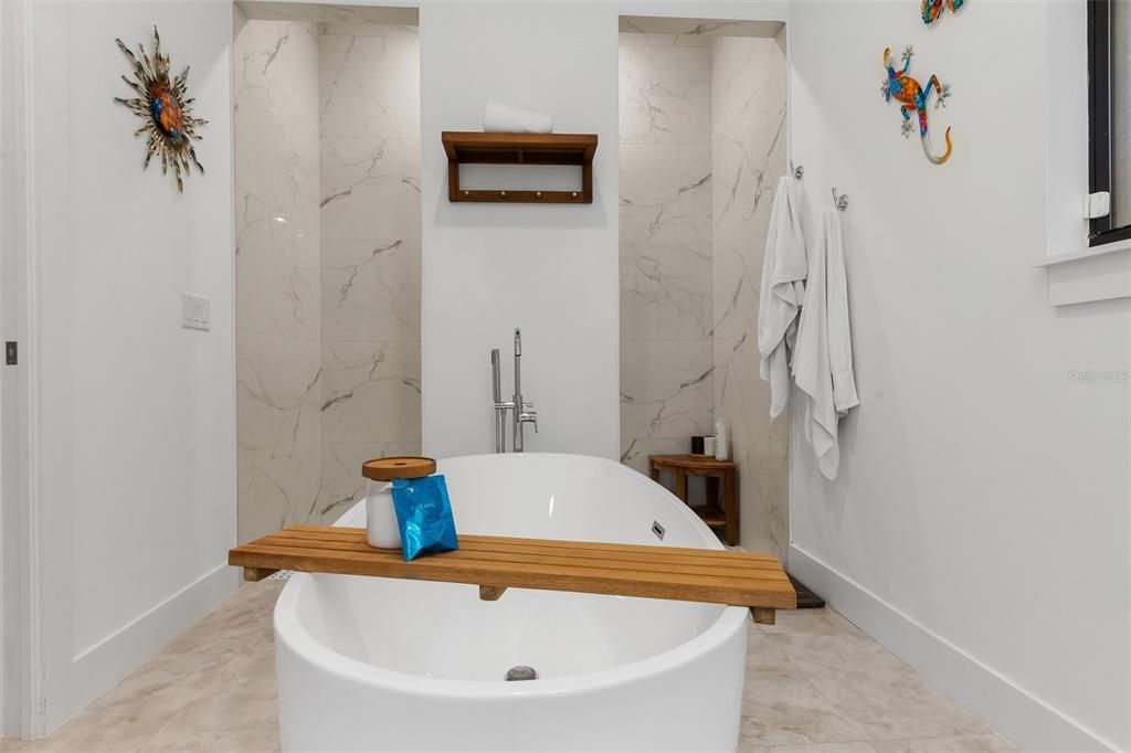 Custom walk through shower behind the soaking tub