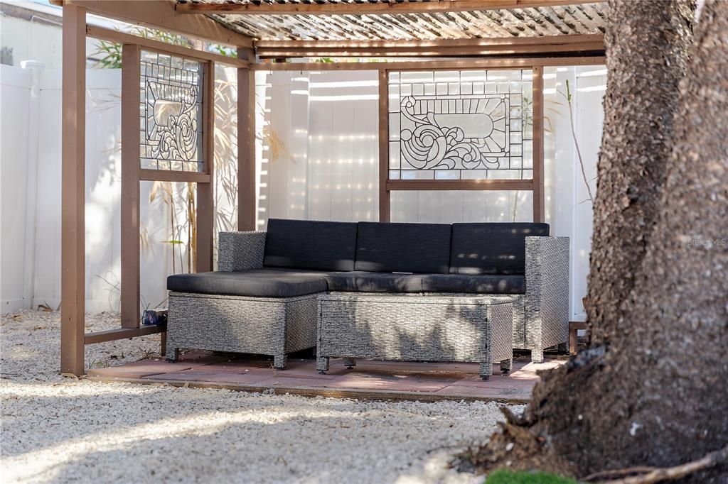 The backyard features cozy corners and vignettes to relax and unwind.