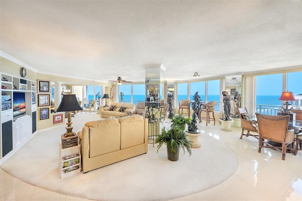 This living room, ,designed for the discerning, offers panoramic views of the ocean that stretch as far as the eye can see.