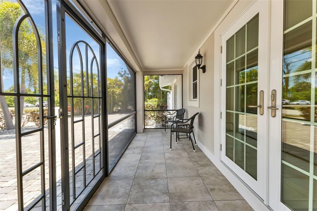 Screened in entry way with impact French doors.