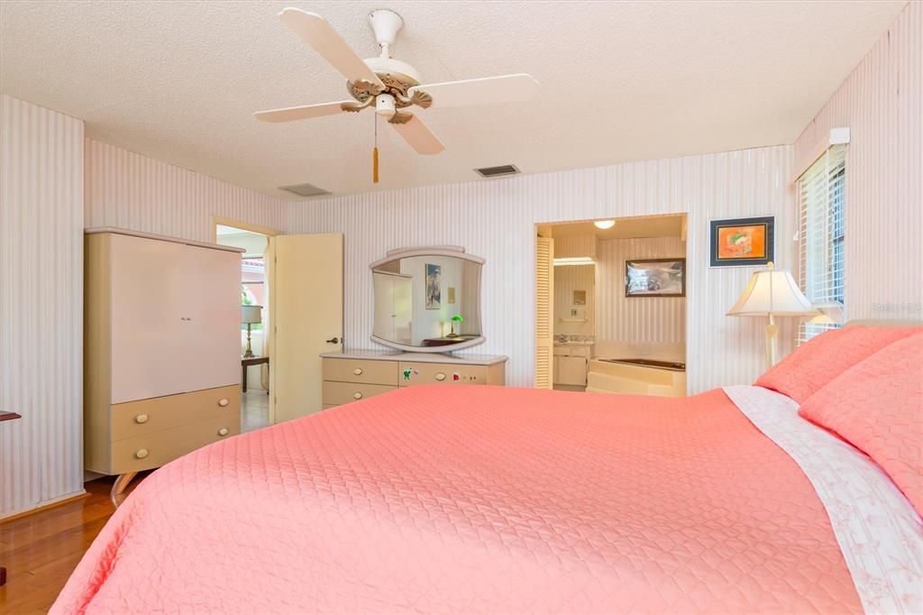 The primary bedroom features hardwood floors.