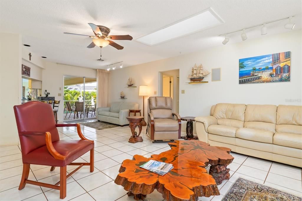 Family room with direct access to lanai, guest bedrooms, guest bath and kitchen.