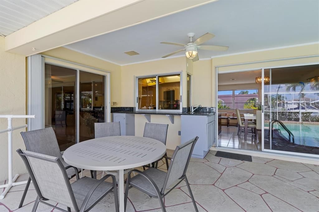 A pass-through window from the kitchen, plus slider access from breakfast nook, dining area, primary bedroom and guest bedroom makes this the perfect area to congregate and enjoy the Florida Lifestyle!