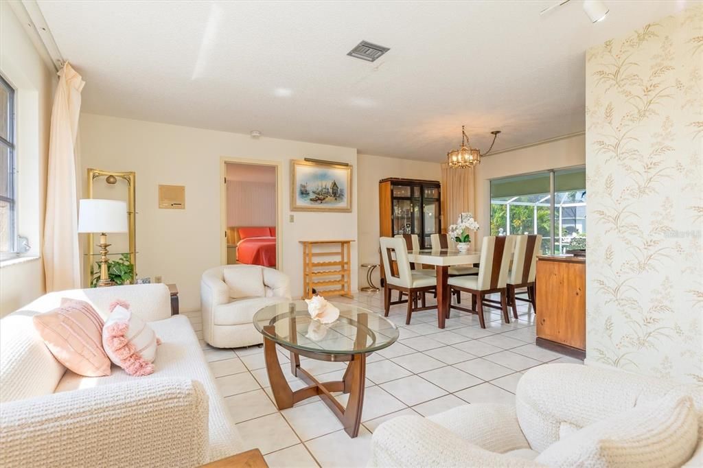 Natural light floods the L-shaped living/dining area combination. Pocketed sliders lead to the lanai and pool area.