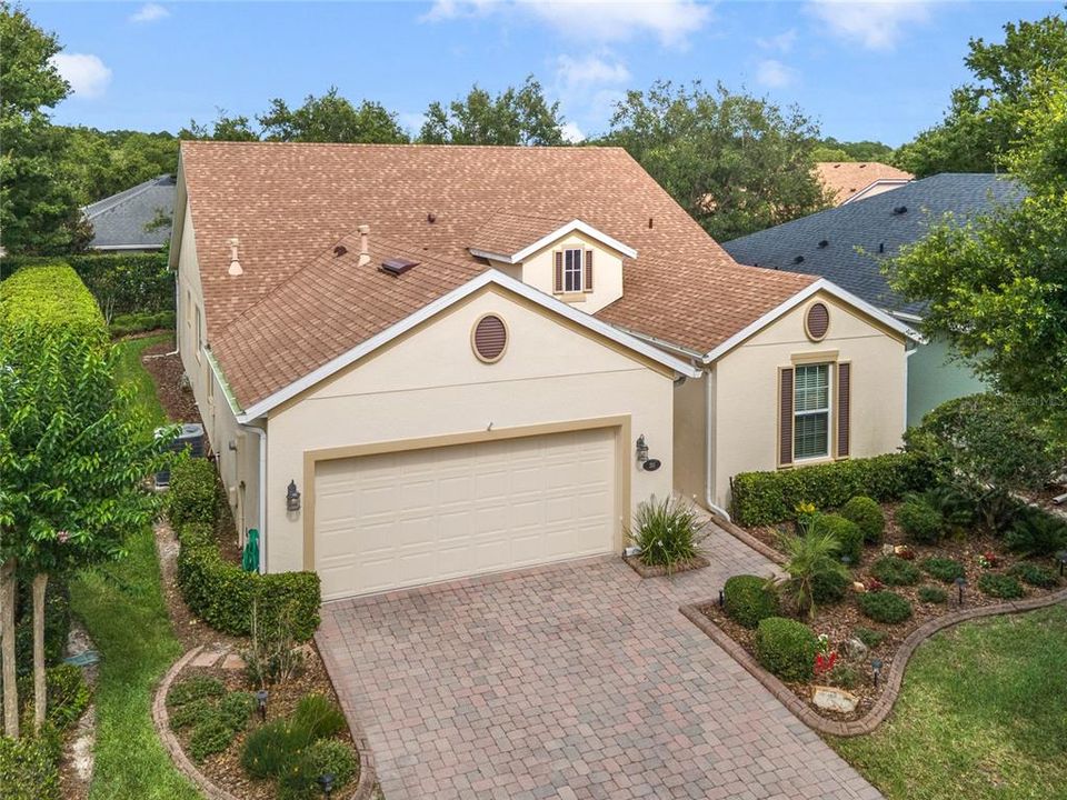 Aerial view of front exterior w/ concrete landscape border