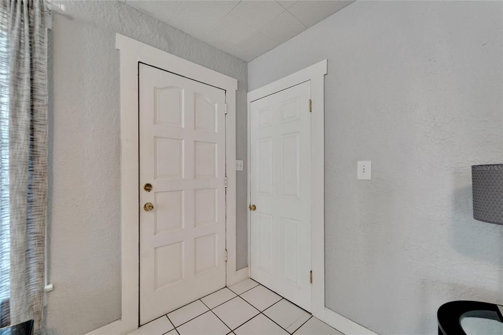 Front door of main home with door to upstairs.