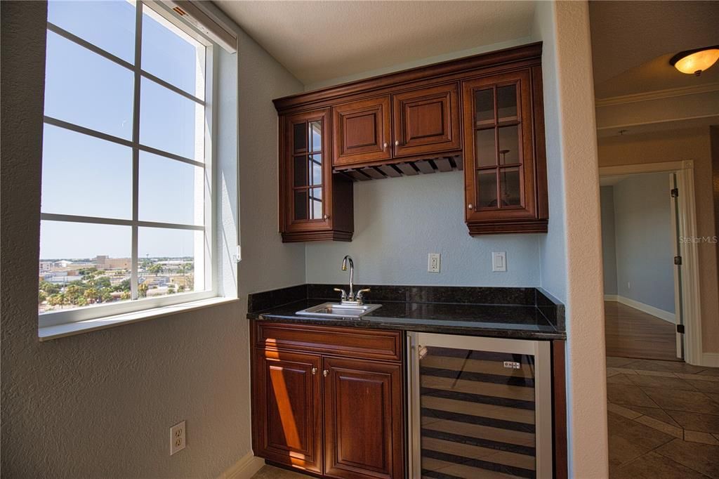 Custom built-in wet bar with wine fridge