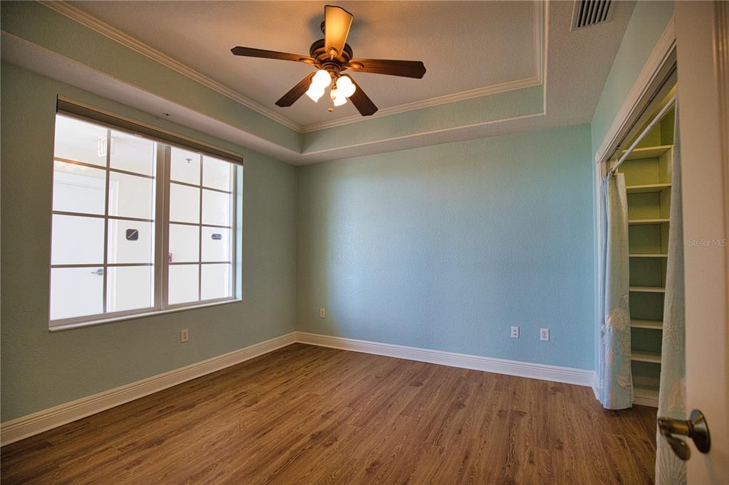 Guest bedroom with tray ceiling - split floorplan for privacy