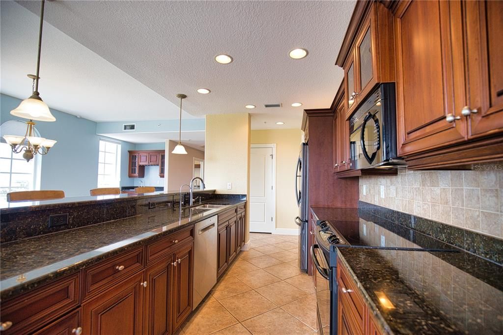 13-foot long breakfast bar - great for entertaining. Sleek and clean stone counters and elevated solid wood cabinets.