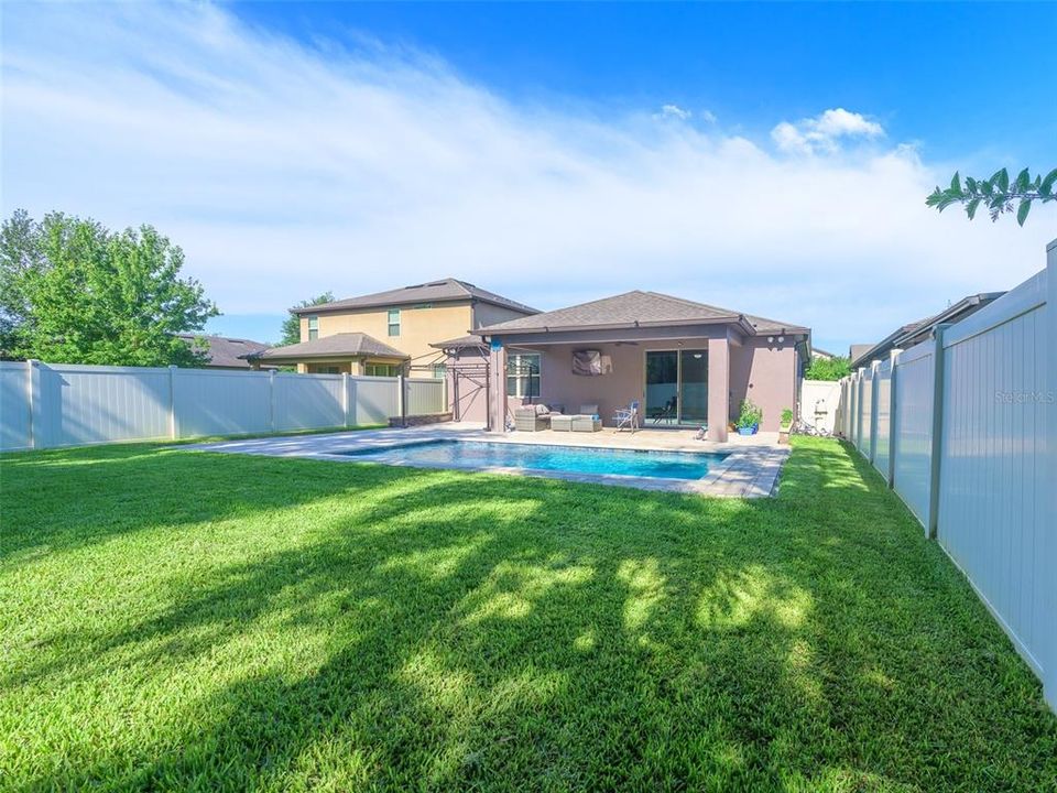 Lush grass and fully fenced yard.