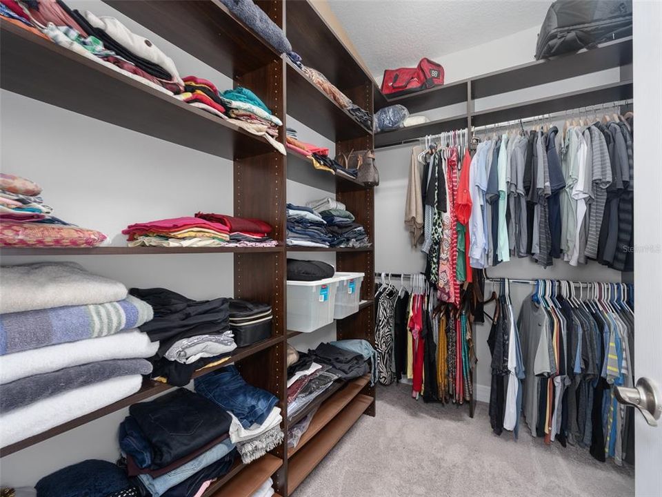 Primary closet with built-in storage.