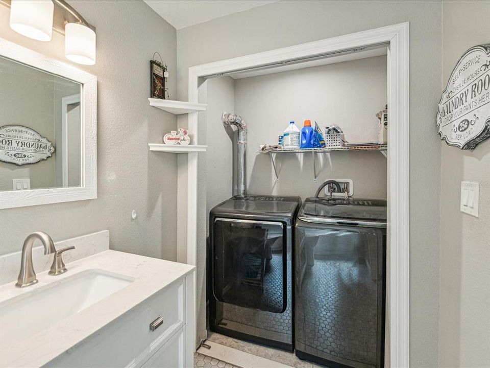 The laundry area is accessible from the bathroom.