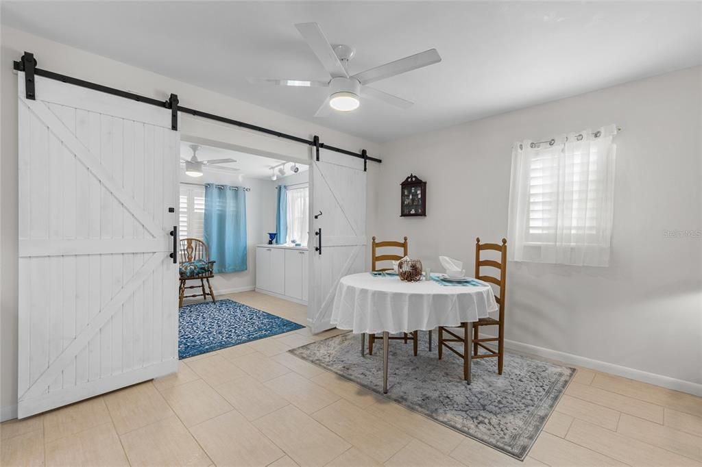 Galley style kitchen with solid surface counters, ample cabinetry, and stainless steel appliances.