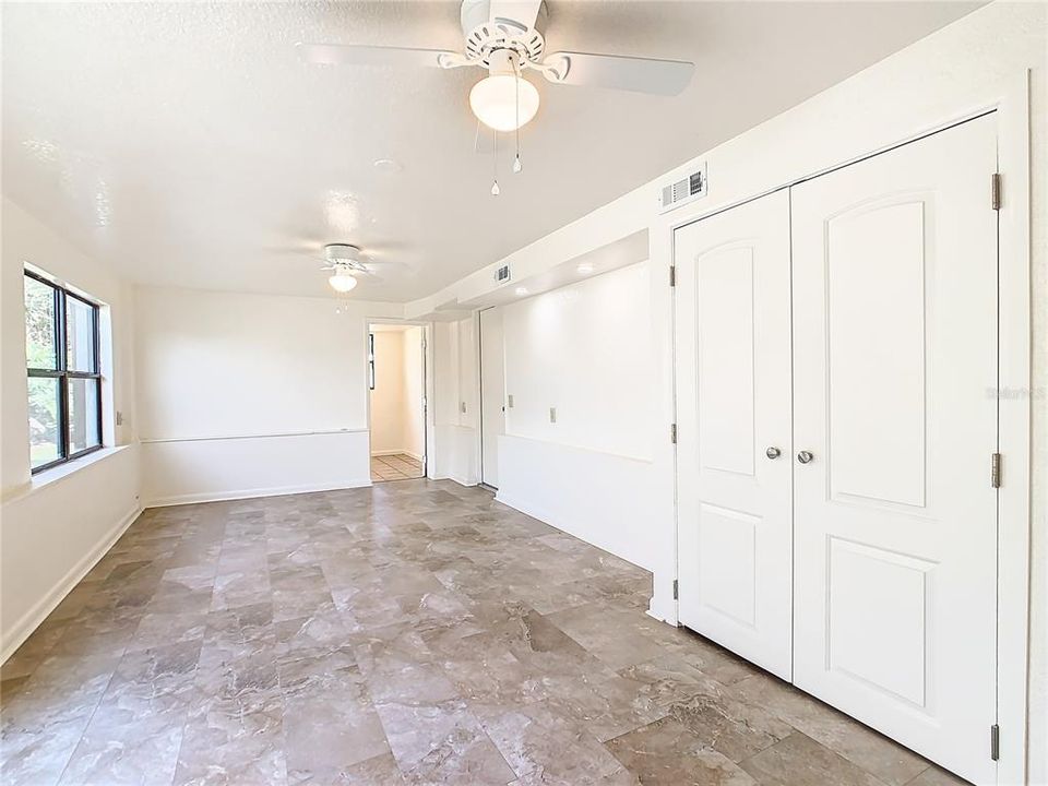 Living room looking to bedroom #2.  Beautiful new flooring, ceiling fans with lights and new paint.