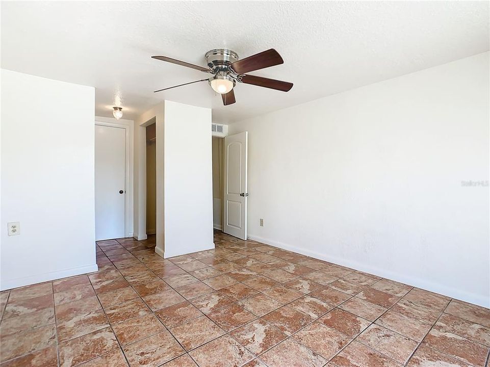 Master bedroom has ceramic tile flooring, new paint and ceiling fan with light.  The closet is at the back of the room.