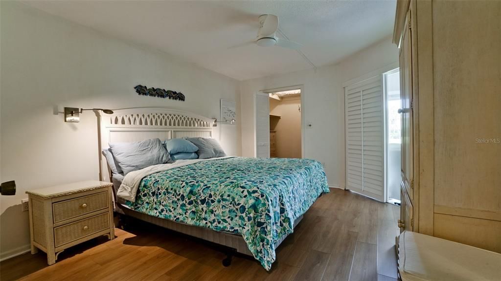 MASTER SUITE HAS ACCESS TO LANAI THROUGH BERMUDA SHUTTER DOORS. VINYL PLANK FLOORING IN BOTHBEDROOMS