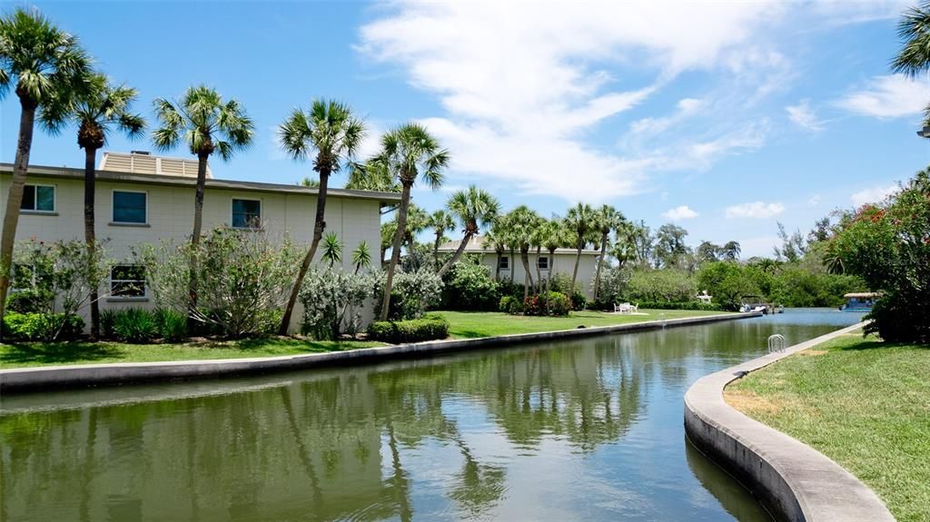 FIRST FLOOR END UNIT WITH LARGE SLIDERS LEADING TO THE BACKYARD & THE CANAL